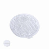 A clear, round hot-cold pack with gel beads, accompanied by a small circular button for activation. A clear, round hot-cold pack with gel beads, accompanied by a small circular button for activation.
