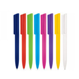 A collection of plastic ballpoint pens in various colours: blue, red, green, teal, pink, yellow, purple, and white.