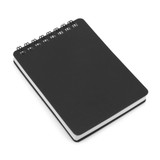 A spiral-bound notepad in black with white pages and a compact A7 size. It features a wire binding at the top.
