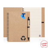 A spiral-bound notebook made of recycled paper in a brown finish, accompanied by a black pen. It features a logo.