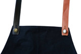 A black apron with changeable PU cross-back straps in black and brown, featuring metal buttons. A black apron with changeable PU cross-back straps in black and brown, featuring metal buttons.