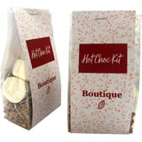 A packaged hot chocolate kit featuring white marshmallows and chocolate flakes in a vibrant red and white design. A packaged hot chocolate kit featuring white marshmallows and chocolate flakes in a vibrant red and white design.