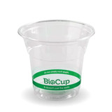 A clear plastic cup with a green band, labelled BioCup, made from plant-based materials.