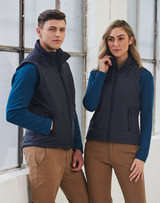 A navy padded vest featuring a zip front and side pockets, modeled by a man and woman in casual attire. A navy padded vest featuring a zip front and side pockets, modeled by a man and woman in casual attire.