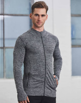 A man wearing a grey seamless jacket with a zip, featuring a fitted design and pockets.