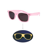 Glow in the dark sunglasses in pink and yellow with dark lenses, featuring a logo on the side.
