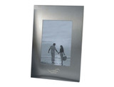 A sleek silver photo frame featuring a portrait orientation, designed to hold a single photo.
