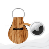 A wooden-textured neoprene keychain with a slot for an AirTag and a metal keyring.