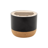 A cylindrical speaker in black with a cork base and a wooden top featuring cut-out slits.