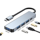 A silver USB hub with multiple ports, including USB 2.0 and USB 3.0, accompanied by various cables.