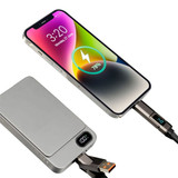 A silver power bank connected to a phone displaying a charging icon and battery percentage. The cable is black with a logo.
