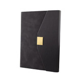 A black notebook with a textured cover and a gold clasp. The design features a unique angled flap and branding.