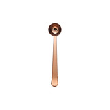 A copper coffee measuring spoon with a clip, featuring a long handle and a rounded scoop at the end.