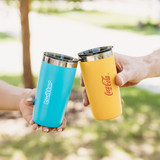 A drink bottle in blue and yellow, featuring logos, with stainless steel interiors, held by two hands.