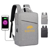 A grey laptop backpack featuring a logo and a USB charging port, with adjustable shoulder straps.