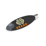 An oval acrylic hair clip in black and white features a logo and an orange accent.