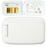A white sewing kit with various threads, buttons, safety pins, and a needle inside a compact case.