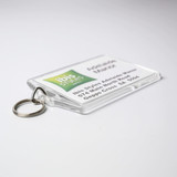 A clear hotel keychain with a keyring, featuring a logo. The background is predominantly white with green accents.