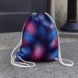 A full-colour drawstring bag in blue, pink, and purple with a patterned design and white drawstrings.