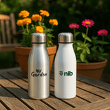 A drink bottle set featuring silver, white, blue, and red aluminium bottles with metal lids and branding areas.
