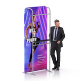 A banner stand display featuring a model in sportswear with a vibrant purple background and a logo on the stand.