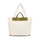 A beige canvas bag with a green leather handle and trim, featuring two long straps for carrying.