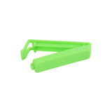 A green food bag seal clip designed to securely close packaging. It features a simple, ergonomic shape.