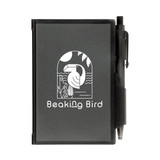 A black Odyssey Pocket Notebook featuring a design with "Beaking Bird" and accompanied by a pen attached to the cover.
