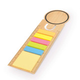 A bamboo bookmark featuring a circular top and multiple colored sticky notes in yellow, pink, and blue.