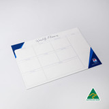 A magnetic whiteboard in white and blue, featuring a weekly planner layout with multiple sections.