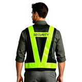 A reflective adjustable safety vest in fluorescent yellow with a pocket, worn by a person from the back.