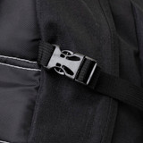 A close-up of a black backpack strap featuring a plastic buckle and stitched detailing.