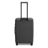 A medium-sized suitcase in matte black, featuring a retractable handle and wheels for easy mobility.