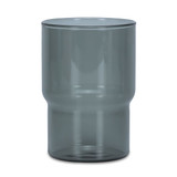 A drink tumbler in a transparent smokey grey colour with a distinctive curved design. Includes a logo.