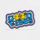 A colourful sticker featuring the phrase "Good Vibes" with smiling faces and floral designs in bright hues.