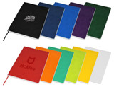 A range of A5 notebooks in various colours, including black, blue, purple, red, green, orange, yellow, and white, with branding on some.