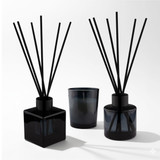 An Aroma Diffuser and Candle Gift box featuring two black diffusers and a matching candle, all in sleek glass containers.