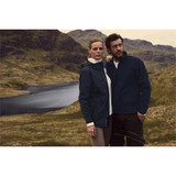 A men’s navy rain jacket displayed on a model, surrounded by a scenic landscape with water and greenery.