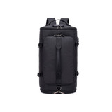 A black convertible bucket backpack duffel bag with multiple straps and a zipped compartment. It features a logo.