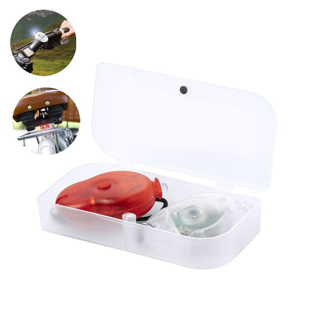 A bike safety light set in a clear case, featuring a red light and a green light, ready for use. A bike safety light set in a clear case, featuring a red light and a green light, ready for use.