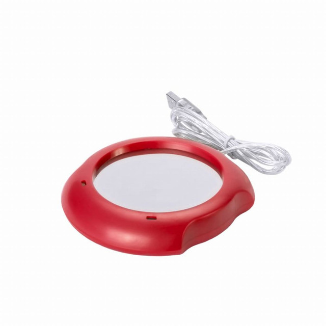 A red cup warmer with a USB cable attached and a smooth, reflective surface. It has a circular design. A red cup warmer with a USB cable attached and a smooth, reflective surface. It has a circular design.