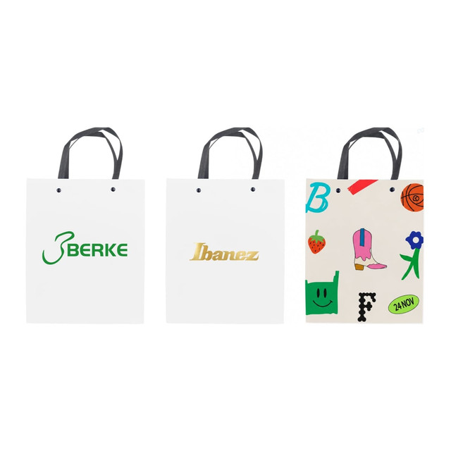 A collection of three white paper bags with knitted handles, each featuring different logos and colourful designs.