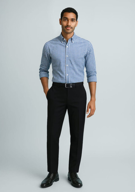 A man wearing a blue and white checked shirt paired with black slimline pants and dress shoes.