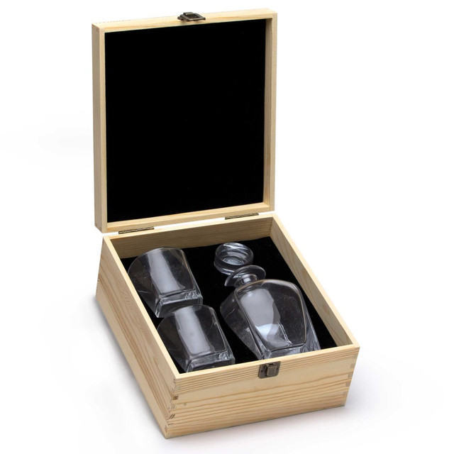 A glass decanter and two tumblers in a wooden box with a black velvet interior. The glassware is clear.
