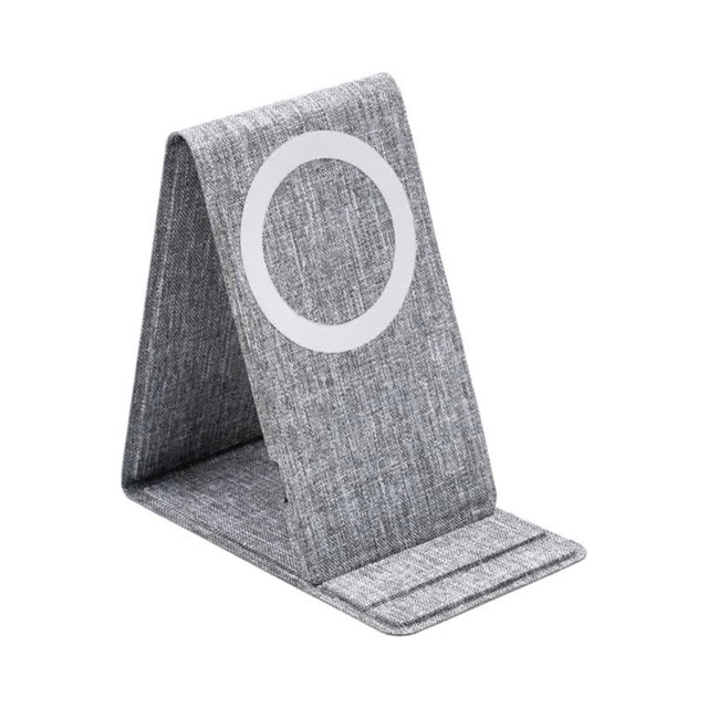 A grey wireless charger with a textured fabric design and a circular charging pad. A grey wireless charger with a textured fabric design and a circular charging pad.