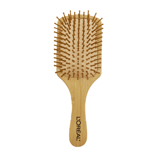 A bamboo hairbrush with a flat paddle design and rounded wooden bristles. Features a branding logo on the handle. A bamboo hairbrush with a flat paddle design and rounded wooden bristles. Features a branding logo on the handle.