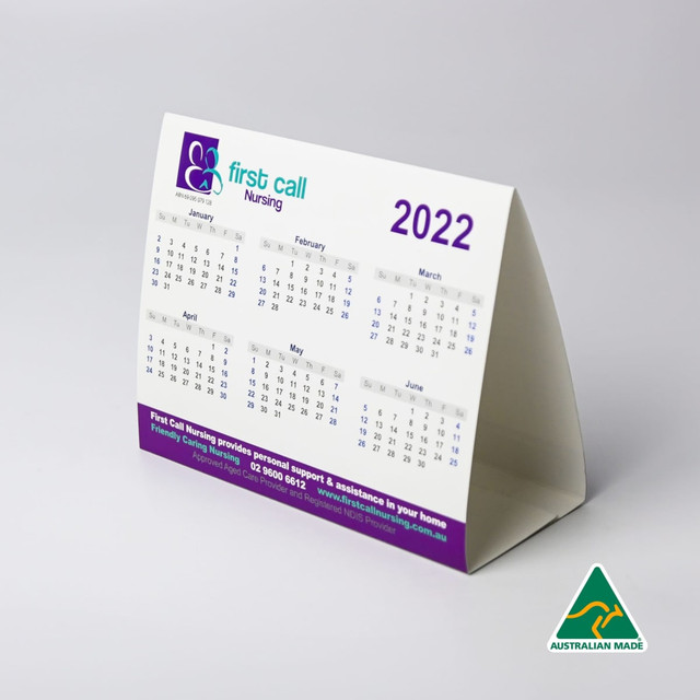 A desk calendar featuring a white background with purple accents, displaying month grids for 2022. It has a logo.
