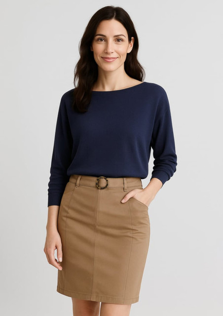 A navy batwing sweater top paired with a tan skirt. The model has long, dark hair and smiles at the camera.