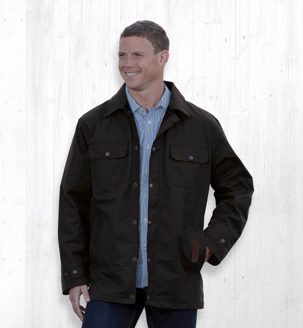 A dark brown oilskin jacket with pockets and a front button closure, displayed on a smiling model against a light background. A dark brown oilskin jacket with pockets and a front button closure, displayed on a smiling model against a light background.