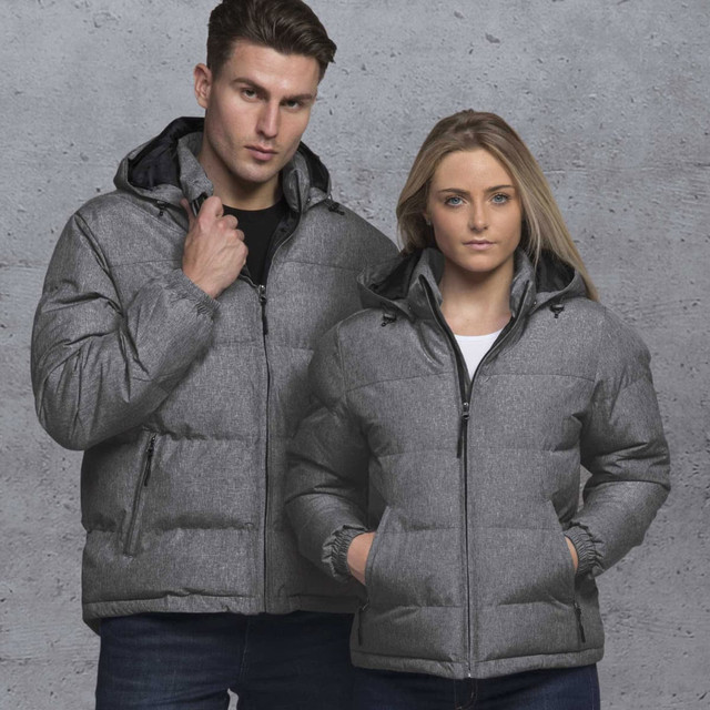 A grey puffer jacket featuring a hood, designed for both men and women, with visible branding. A grey puffer jacket featuring a hood, designed for both men and women, with visible branding.